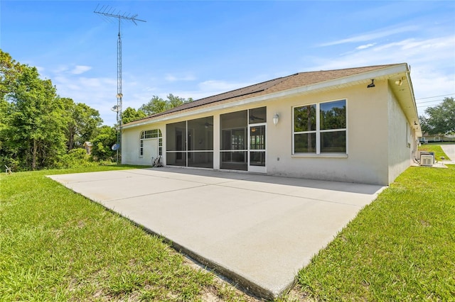7206 River Country Dr, Weeki Wachee, FL 34607 - back of house featuring stucco siding, a sunroom, a yard, and a patio area