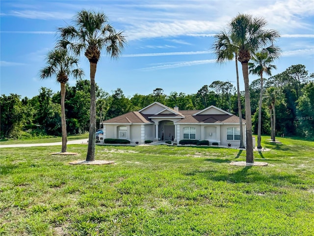 7206 River Country Dr, Weeki Wachee, FL 34607 - ranch-style home with a front lawn and view of wooded area