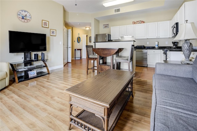 13235 Gulf Blvd Unit 402, Saint Petersburg, FL 33708 - living area with light wood-type flooring and baseboards