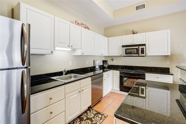 13235 Gulf Blvd Unit 402, Saint Petersburg, FL 33708 - kitchen featuring appliances with stainless steel finishes, a sink, white cabinetry, and light tile patterned floors