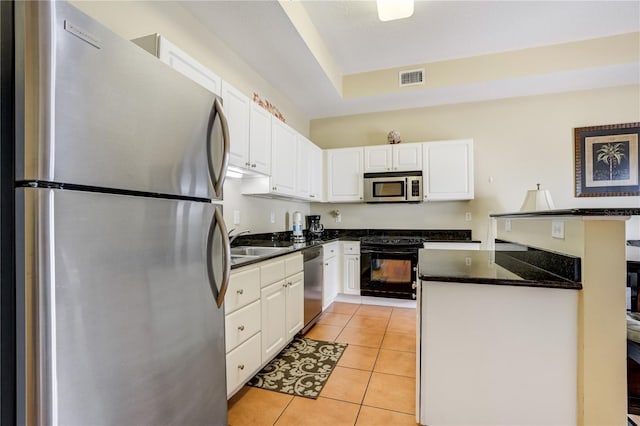 13235 Gulf Blvd Unit 402, Saint Petersburg, FL 33708 - kitchen featuring appliances with stainless steel finishes, a sink, and white cabinetry