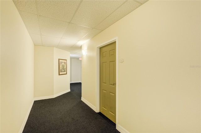 13235 Gulf Blvd Unit 402, Saint Petersburg, FL 33708 - corridor featuring a drop ceiling, dark carpet, and baseboards