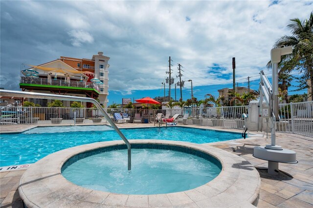 13235 Gulf Blvd Unit 402, Saint Petersburg, FL 33708 - community pool featuring fence, a community hot tub, and a patio area
