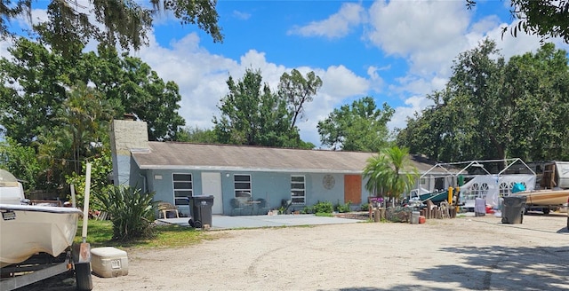 1114 27th St SE Unit A, Ruskin, FL 33570 - view of front of home featuring a chimney and stucco siding
