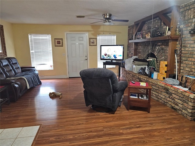 1114 27th St SE Unit A, Ruskin, FL 33570 - living room featuring wood finished floors, ceiling fan, baseboards, and a large fireplace