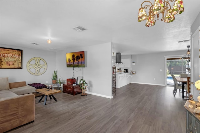 4727 Wales St, Lake Wales, FL 33859 - living room featuring a chandelier, dark wood-style flooring, and baseboards