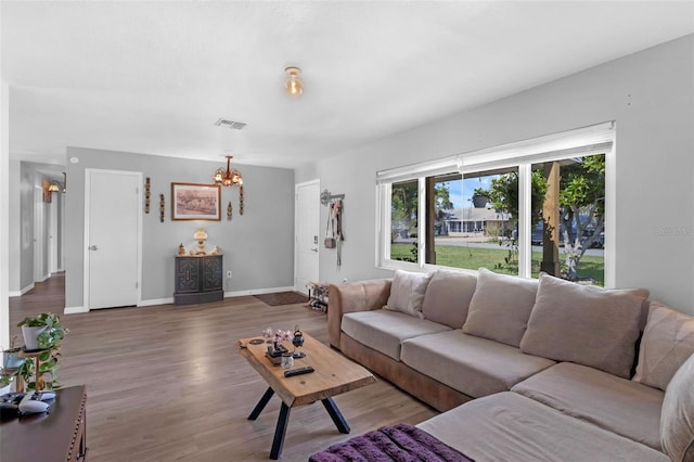 4727 Wales St, Lake Wales, FL 33859 - living room featuring a chandelier, wood finished floors, and baseboards
