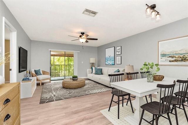 living area featuring a ceiling fan and light wood finished floors