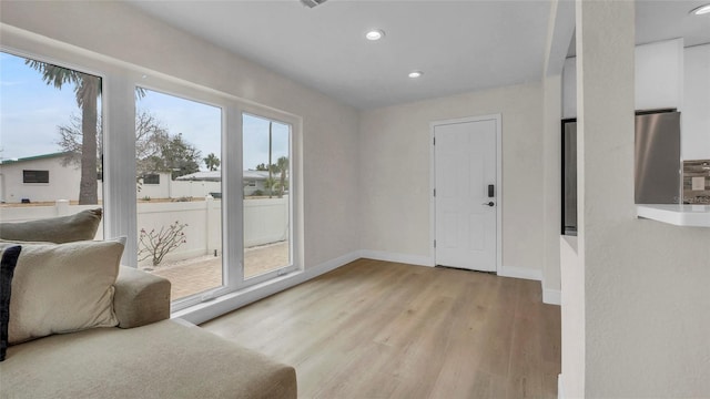 281 44th Ave, St Pete Beach, FL 33706 - doorway to outside featuring light wood finished floors, recessed lighting, and baseboards