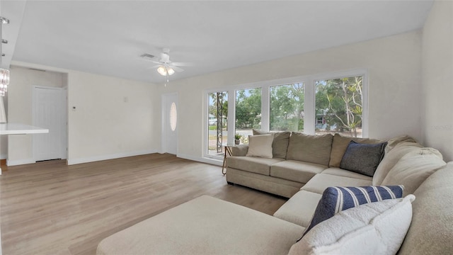 281 44th Ave, St Pete Beach, FL 33706 - living area with wood finished floors, a ceiling fan, and baseboards
