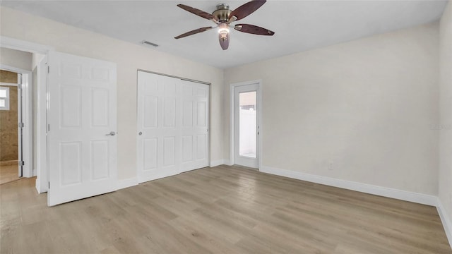 281 44th Ave, St Pete Beach, FL 33706 - unfurnished bedroom featuring light wood-style floors, baseboards, a closet, and a ceiling fan