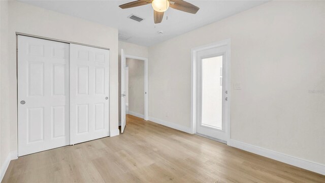 281 44th Ave, St Pete Beach, FL 33706 - unfurnished bedroom featuring light wood-style floors, baseboards, a closet, and ceiling fan