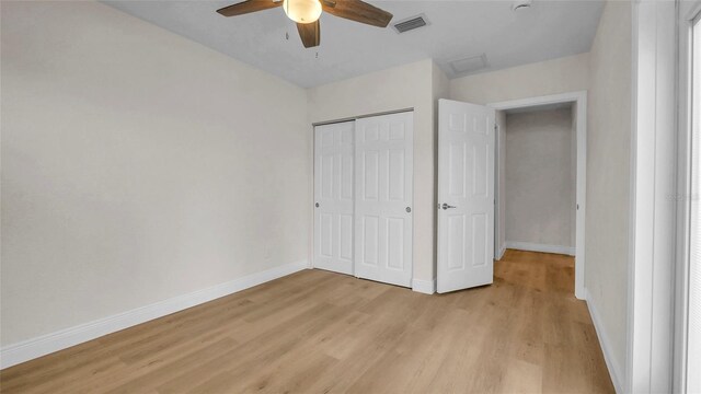 281 44th Ave, St Pete Beach, FL 33706 - unfurnished bedroom featuring light wood-style flooring, baseboards, a closet, and a ceiling fan