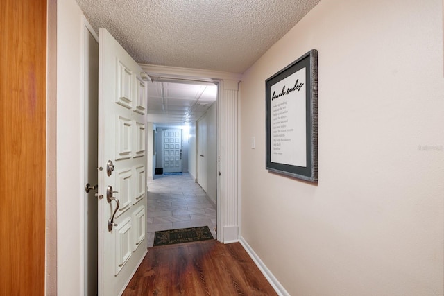 17408 Gulf Blvd Unit 203, Redington Shores, FL 33708 - corridor with baseboards, a textured ceiling, and dark wood finished floors