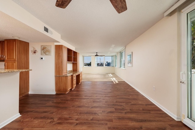 17408 Gulf Blvd Unit 203, Redington Shores, FL 33708 - hall featuring a textured ceiling, dark wood-style flooring, plenty of natural light, and baseboards
