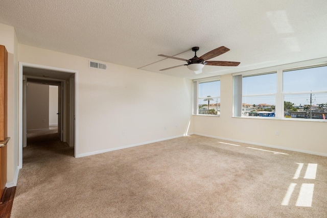 17408 Gulf Blvd Unit 203, Redington Shores, FL 33708 - carpeted empty room with ceiling fan, a textured ceiling, and baseboards