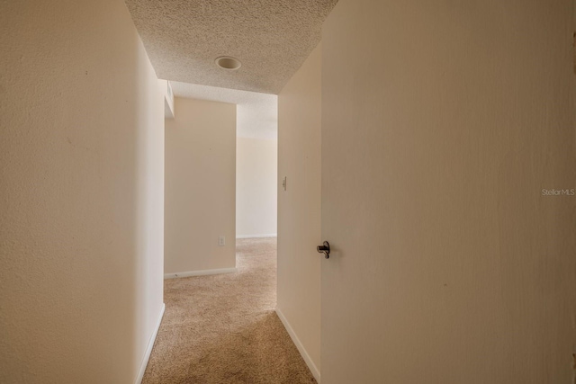 17408 Gulf Blvd Unit 203, Redington Shores, FL 33708 - hallway with carpet, a textured ceiling, and baseboards