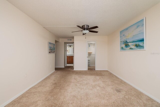 17408 Gulf Blvd Unit 203, Redington Shores, FL 33708 - carpeted empty room with ceiling fan, baseboards, and a textured ceiling