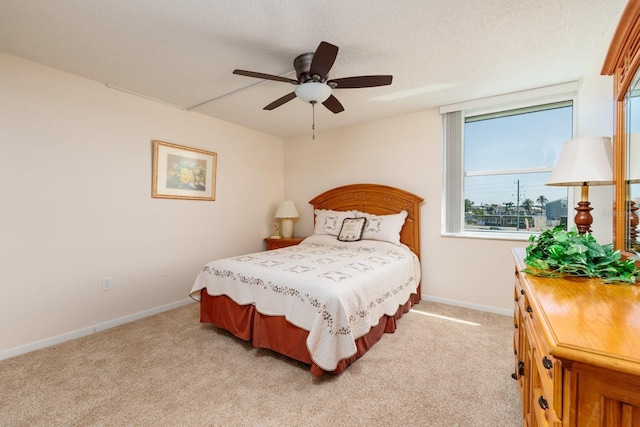 17408 Gulf Blvd Unit 203, Redington Shores, FL 33708 - bedroom featuring light carpet, baseboards, and a ceiling fan