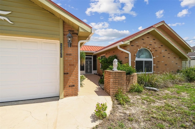 view of front of house with brick siding, concrete driveway, and an attached garage