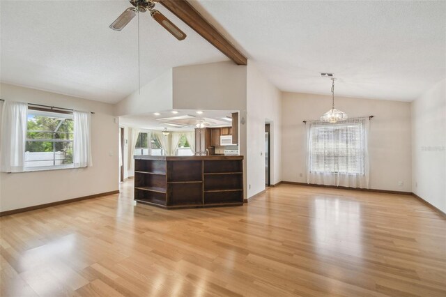 unfurnished living room with ceiling fan, light wood-style flooring, baseboards, high vaulted ceiling, and beamed ceiling