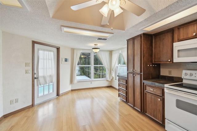 kitchen with white appliances, dark countertops, light wood-type flooring, a textured ceiling, and a ceiling fan
