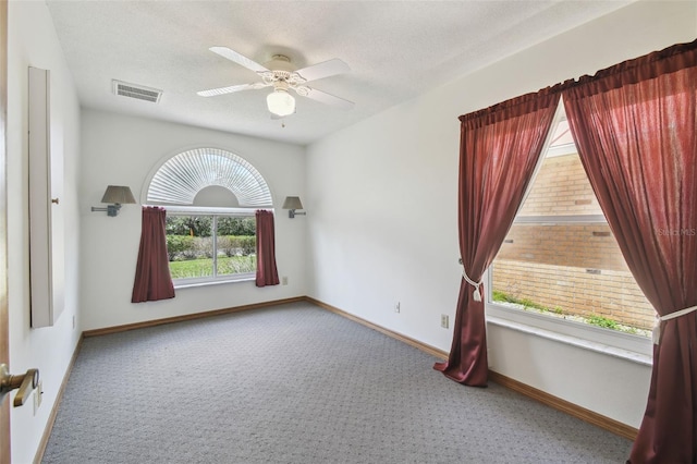 empty room with carpet, ceiling fan, and baseboards