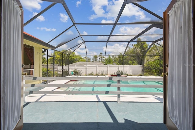 view of swimming pool featuring a patio, a fenced backyard, and a lanai