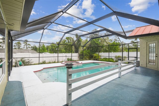 view of swimming pool with a fenced backyard, a patio, a lanai, and a pool with connected hot tub