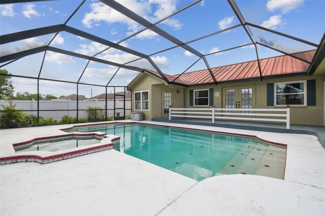view of pool with french doors, a patio, a pool with connected hot tub, and a lanai