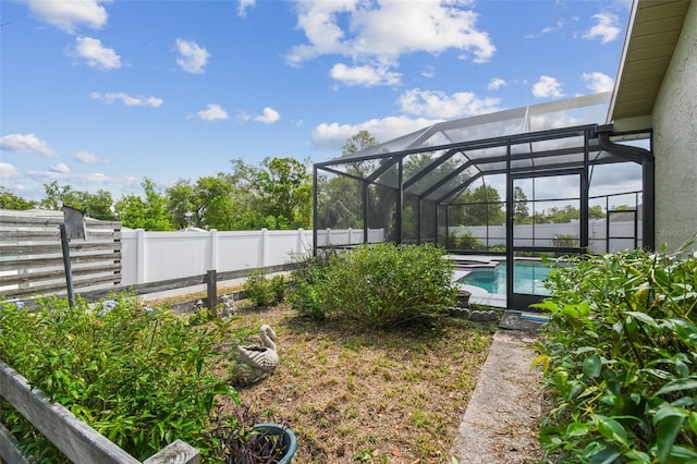 fenced backyard with glass enclosure