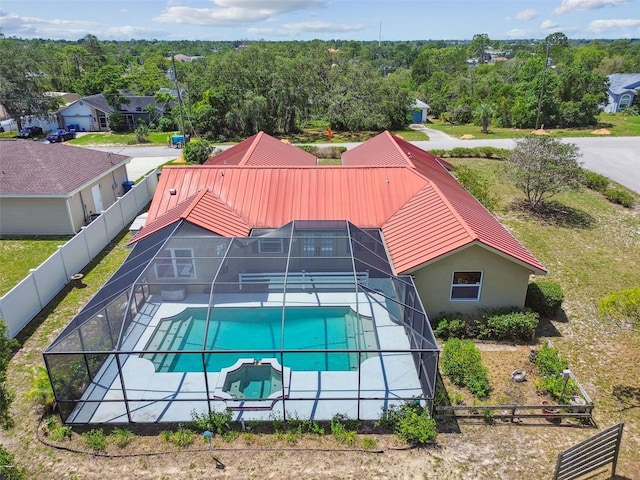 view of swimming pool with a fenced backyard, a patio area, glass enclosure, and a pool with connected hot tub