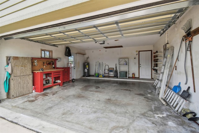 garage featuring water heater, a garage door opener, and a workshop area
