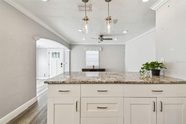 2018 21st St S, Saint Petersburg, FL 33712 - kitchen featuring ornamental molding, light stone countertops, baseboards, white cabinetry, and ceiling fan