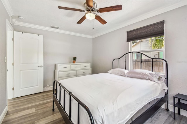2018 21st St S, Saint Petersburg, FL 33712 - bedroom featuring wood finished floors, baseboards, crown molding, and ceiling fan