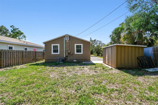2018 21st St S, Saint Petersburg, FL 33712 - rear view of house featuring central air condition unit, stucco siding, an outdoor structure, and a storage shed