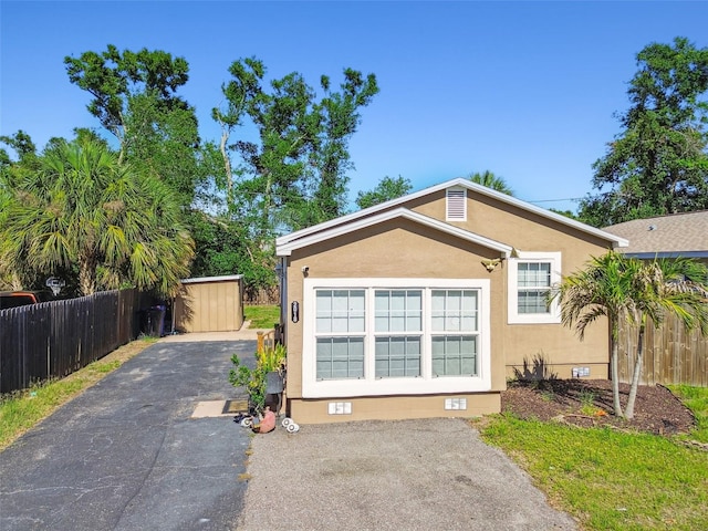 2018 21st St S, Saint Petersburg, FL 33712 - view of front of property with crawl space, fence, asphalt driveway, and stucco siding