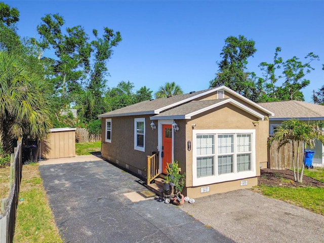 2018 21st St S, Saint Petersburg, FL 33712 - view of front facade with crawl space, roof with shingles, fence, and stucco siding