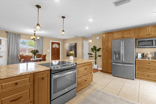 kitchen with appliances with stainless steel finishes, light stone countertops, decorative light fixtures, and light tile patterned floors