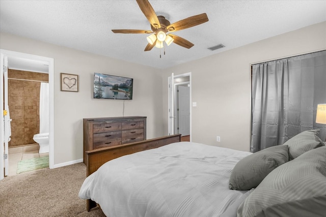 bedroom featuring carpet, a ceiling fan, ensuite bathroom, and a textured ceiling