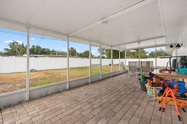 sunroom featuring outdoor dining space