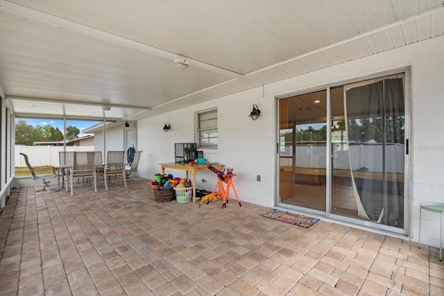 view of patio / terrace featuring outdoor dining area and fence