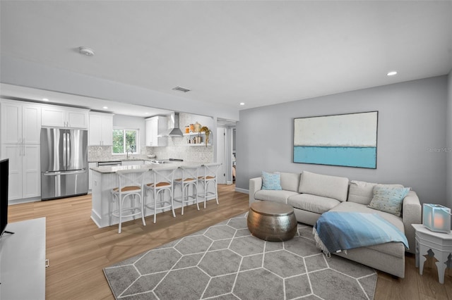 608 Betmor Ln, Palm Harbor, FL 34683 - living room featuring light wood finished floors and recessed lighting