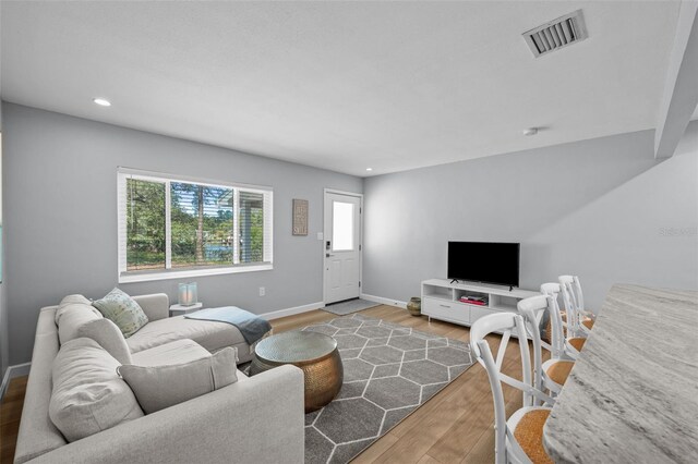 608 Betmor Ln, Palm Harbor, FL 34683 - living room with wood finished floors, baseboards, and recessed lighting