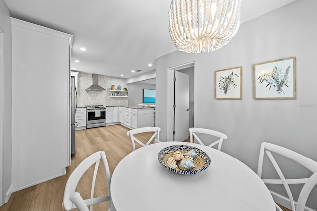 608 Betmor Ln, Palm Harbor, FL 34683 - dining area featuring light wood-type flooring, recessed lighting, and a chandelier