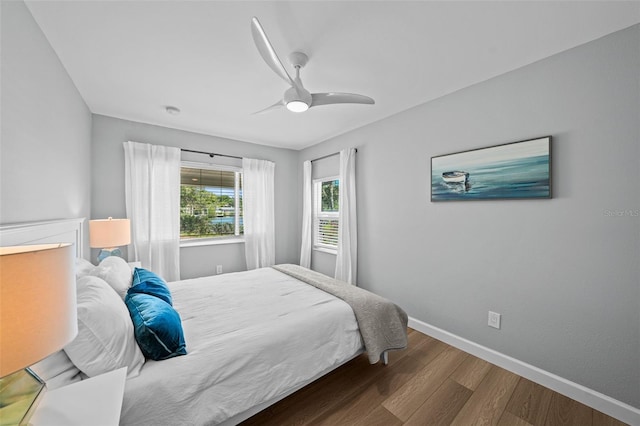 608 Betmor Ln, Palm Harbor, FL 34683 - bedroom with wood finished floors, baseboards, and a ceiling fan
