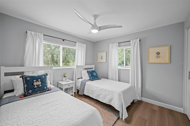 608 Betmor Ln, Palm Harbor, FL 34683 - bedroom with wood finished floors, baseboards, and a ceiling fan
