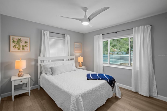 608 Betmor Ln, Palm Harbor, FL 34683 - bedroom featuring baseboards, wood finished floors, and a ceiling fan