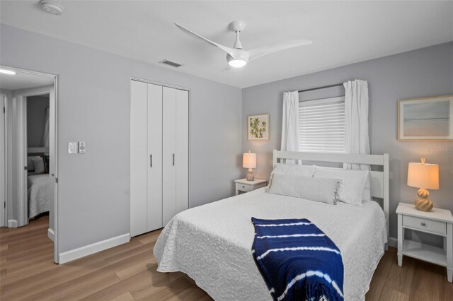 608 Betmor Ln, Palm Harbor, FL 34683 - bedroom featuring wood finished floors, a closet, baseboards, and ceiling fan