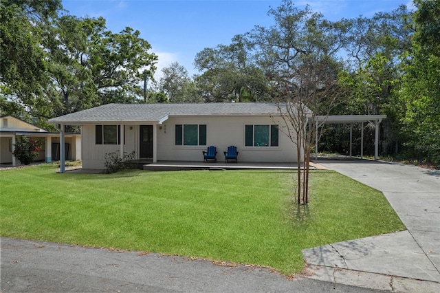 608 Betmor Ln, Palm Harbor, FL 34683 - view of front of property with concrete driveway, a front lawn, and a carport